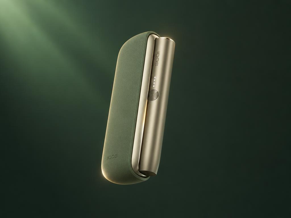 IQOS ILUMA heated tobacco device on an emerald surface